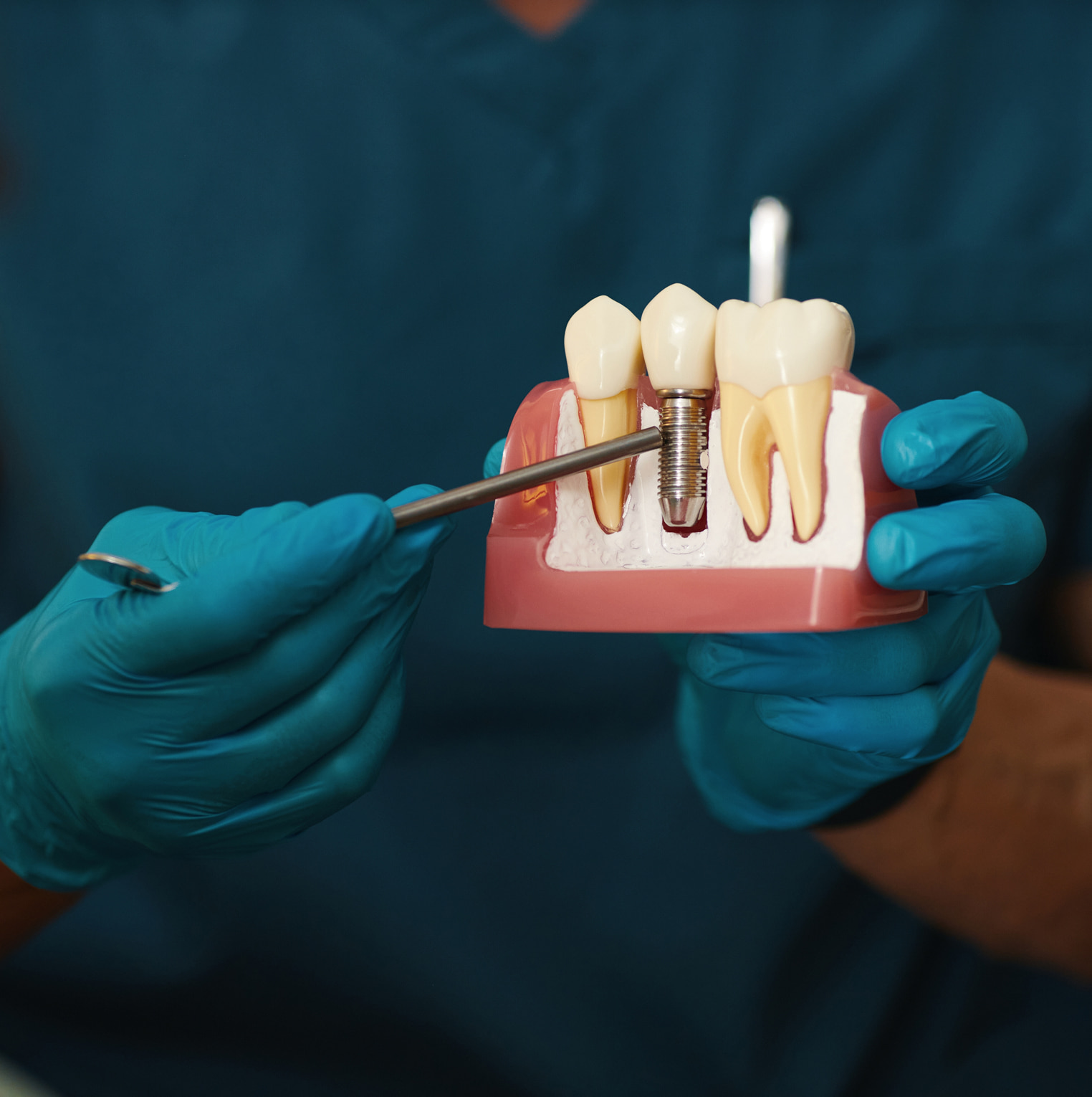 Oral surgeon with specialized training performing dental implants and advanced surgical procedures